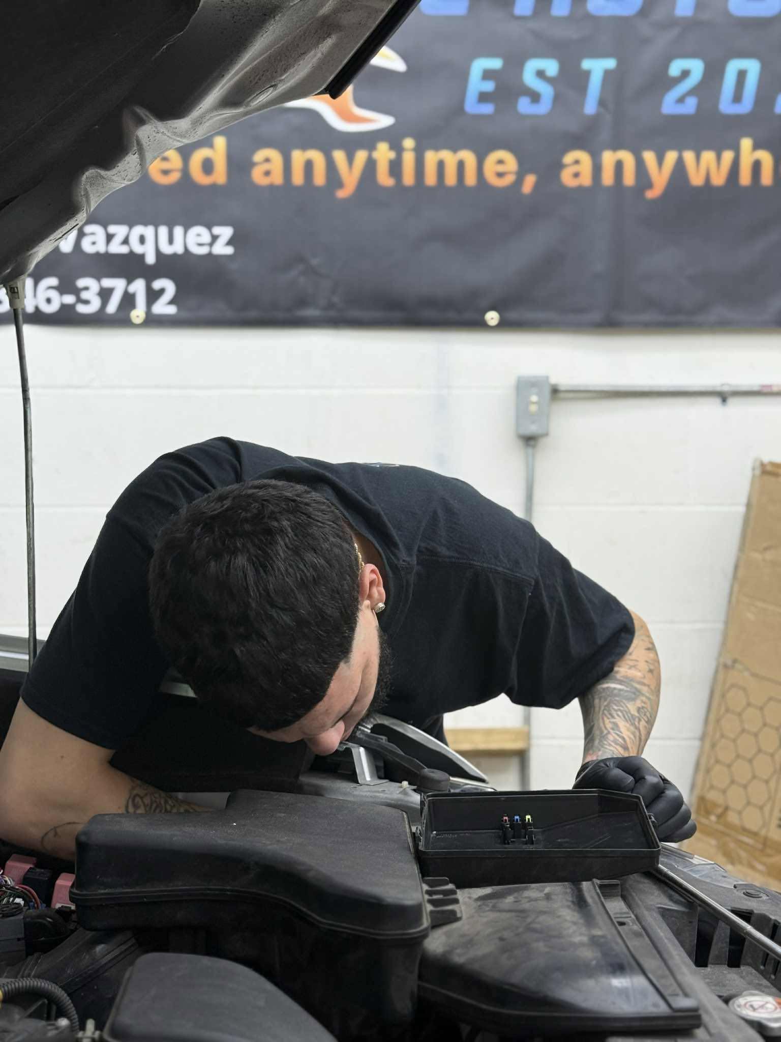 Carlos Vazquez working on a vehicle